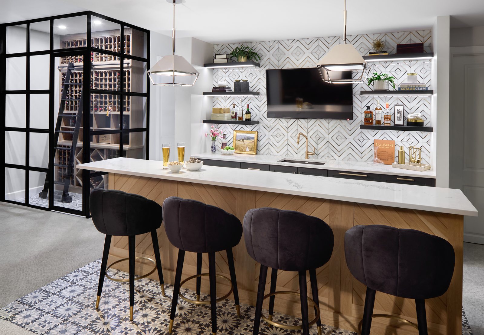 Basement bar with velvet stools, geometric tile backsplash and a steel-framed glass wine room in the Bonnie Brae remodel, Denver.