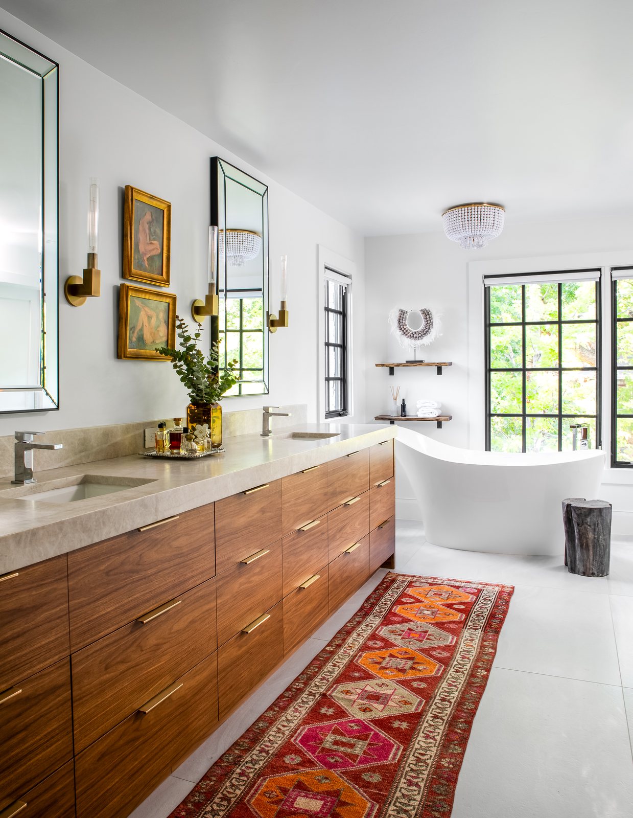 Walnut double vanity, freestanding tub and a vintage red runner in the primary bathroom of the Greenwood Village whole-home remodel.