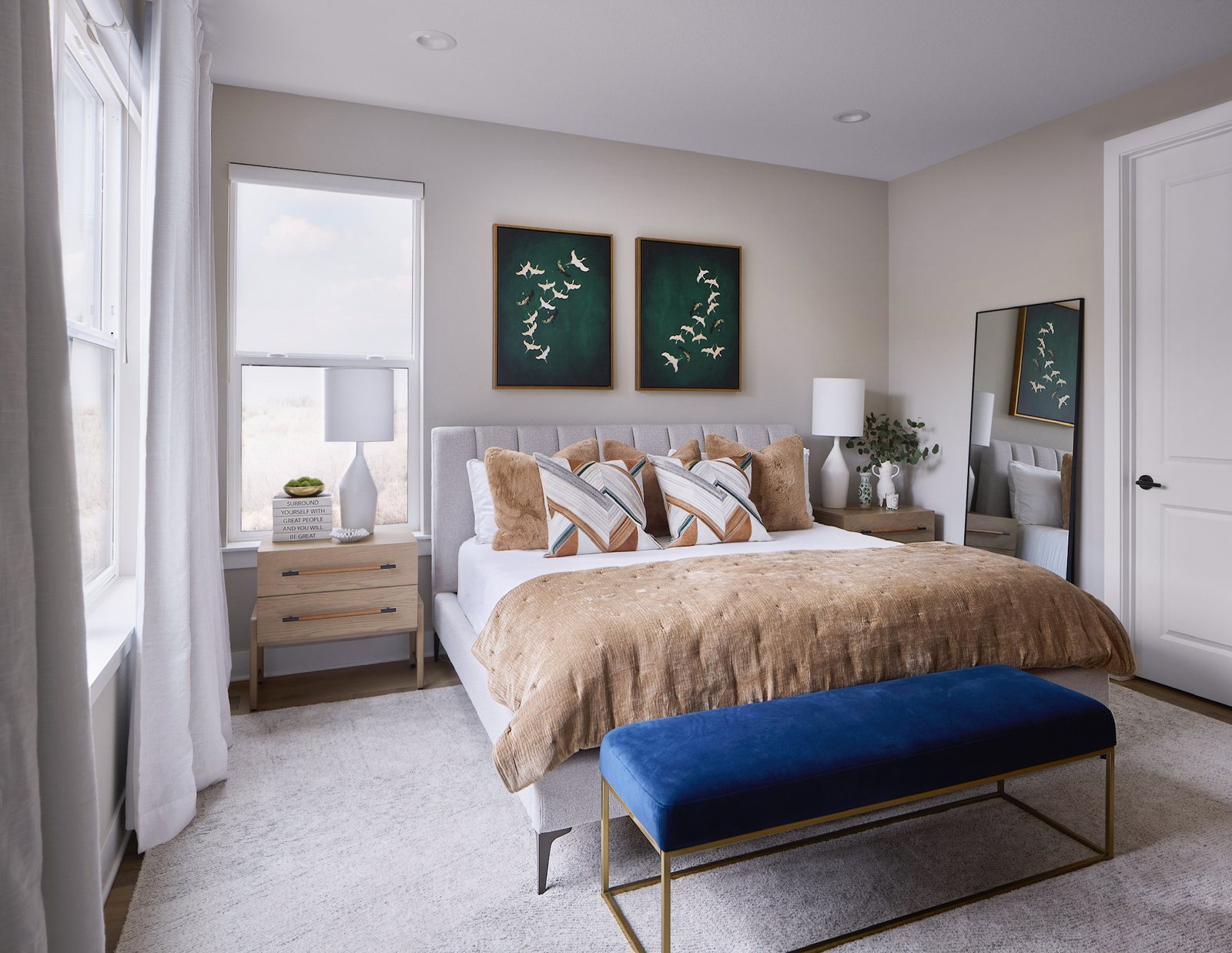 Bedroom with a channel-tufted headboard, gold velvet coverlet, cobalt bench and green crane artwork in The Canyons new build, Castle Pines.