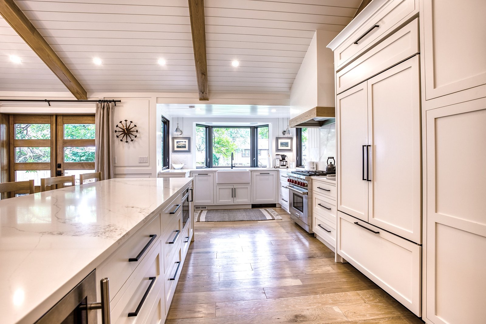 Marble-look island with panel-front appliances and white inset cabinetry, Fulton Street whole house renovation in Greenwood Village