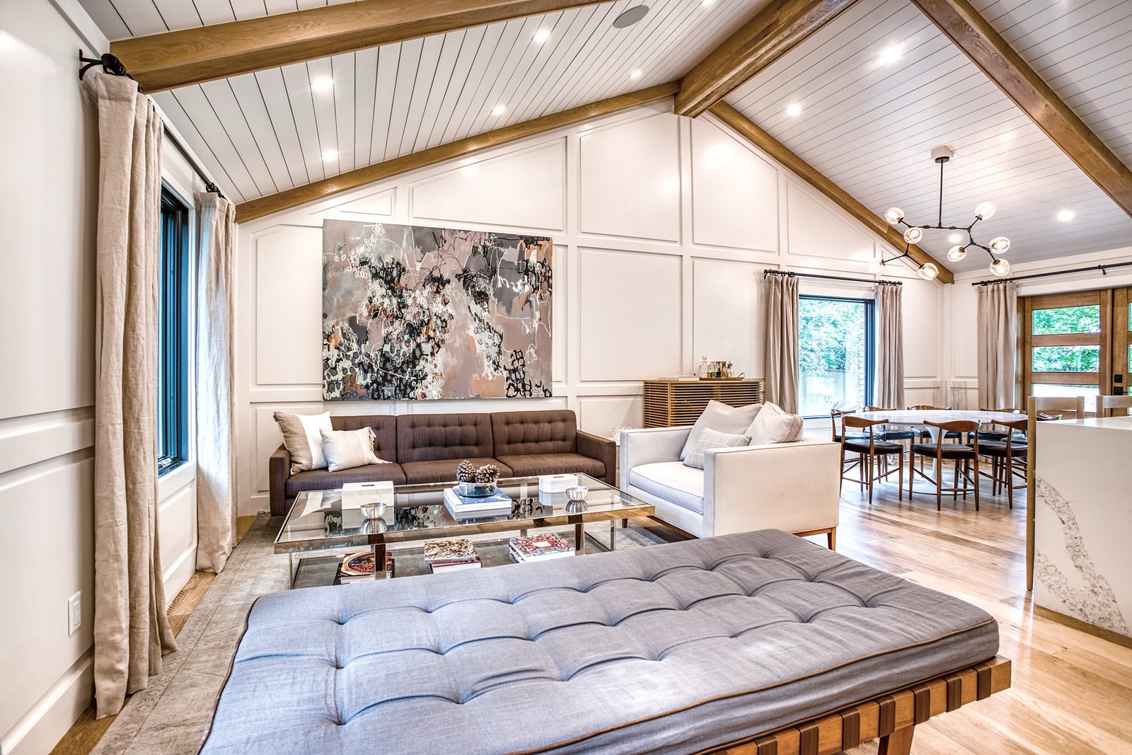 Living room with paneled feature wall, daybed, and layered art, Fulton Street whole house renovation in Greenwood Village