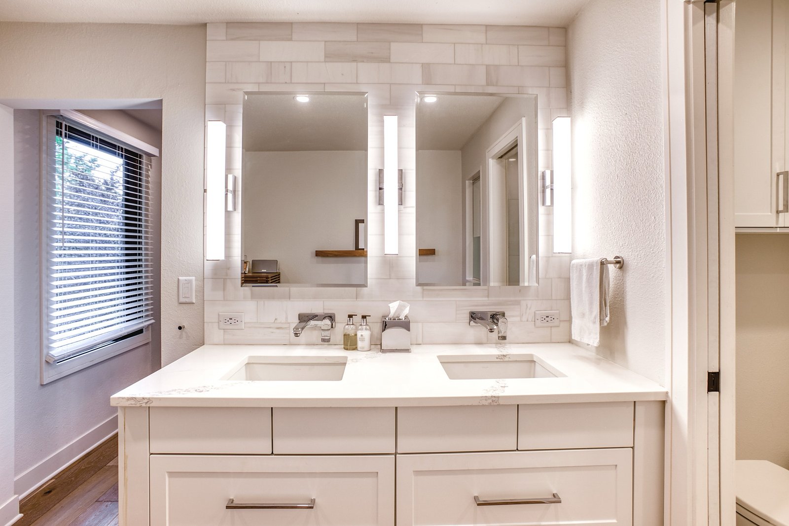 Double vanity with inset cabinets and sconce lighting, Fulton Street whole house renovation in Greenwood Village