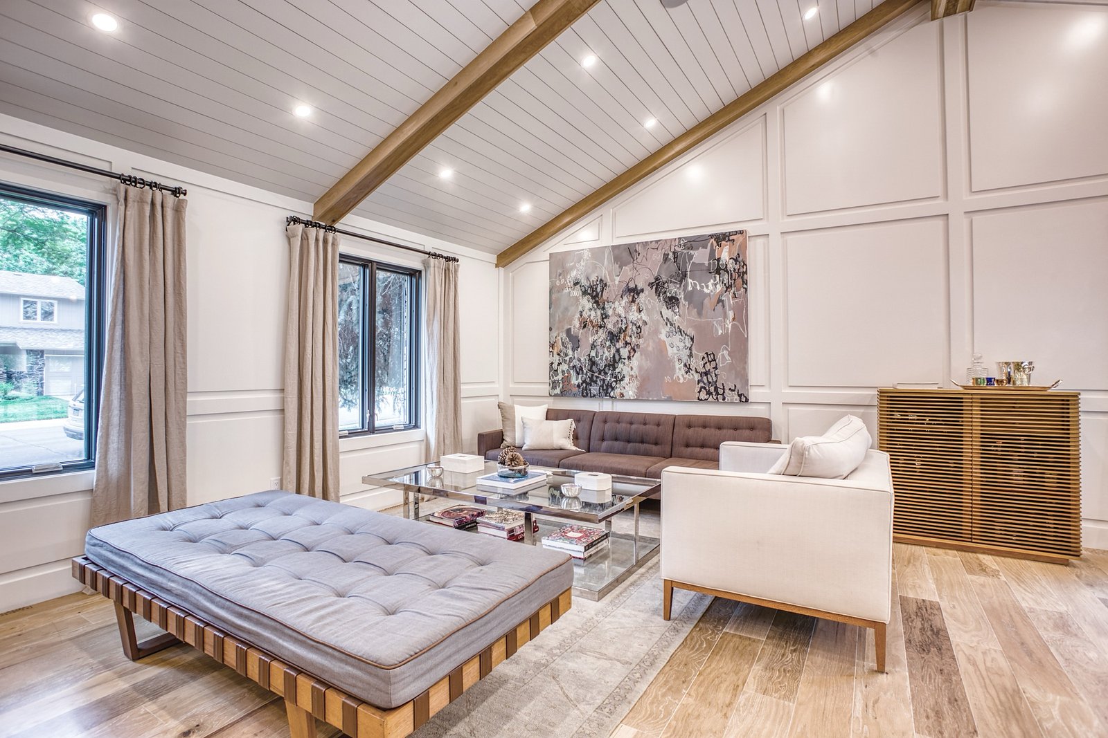 Open great room with kitchen island and dining beneath the beams, Fulton Street whole house renovation in Greenwood Village