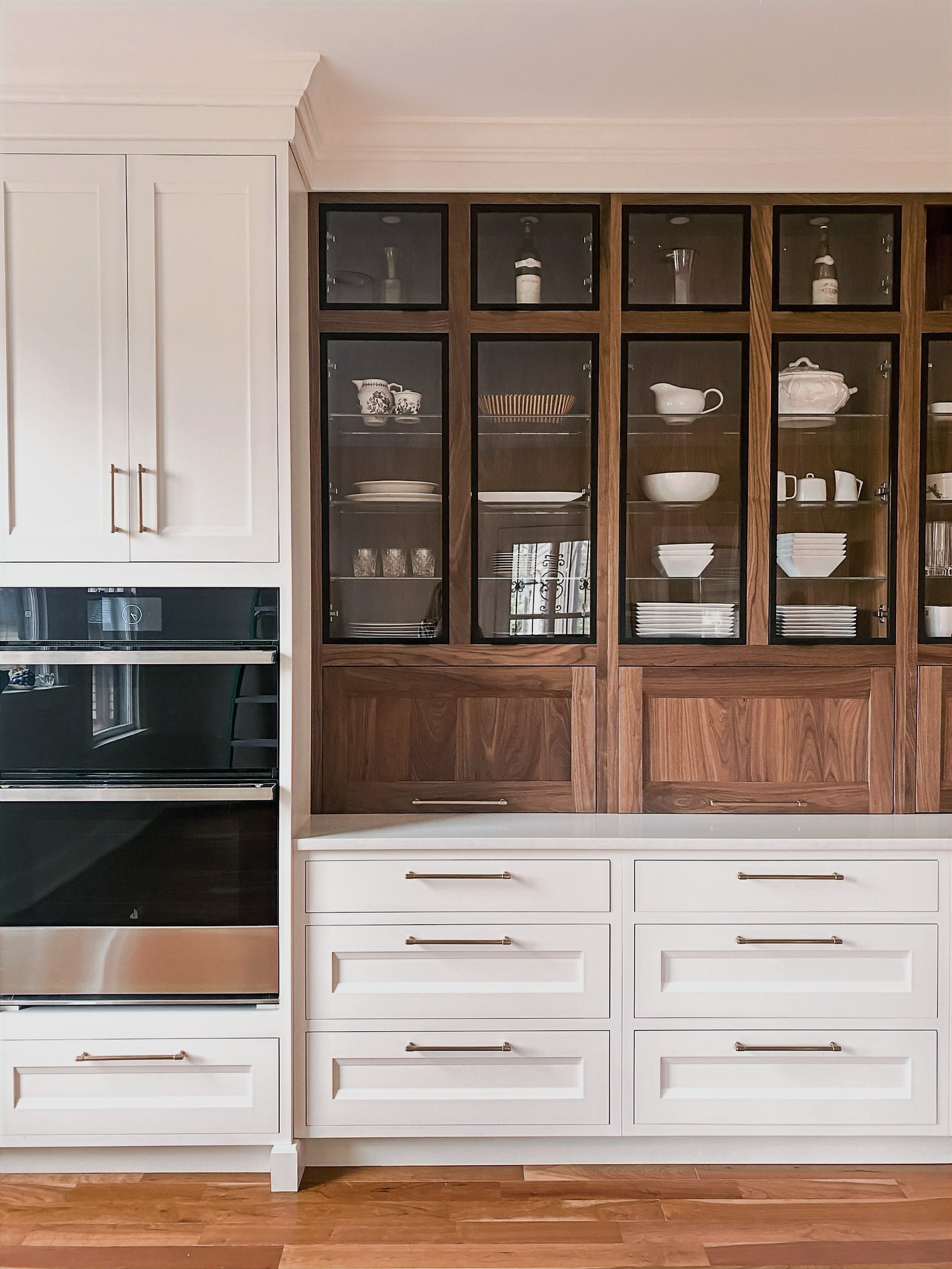 White inset cabinetry with walnut-and-glass upper display hutch, historic Colorado Springs kitchen remodel