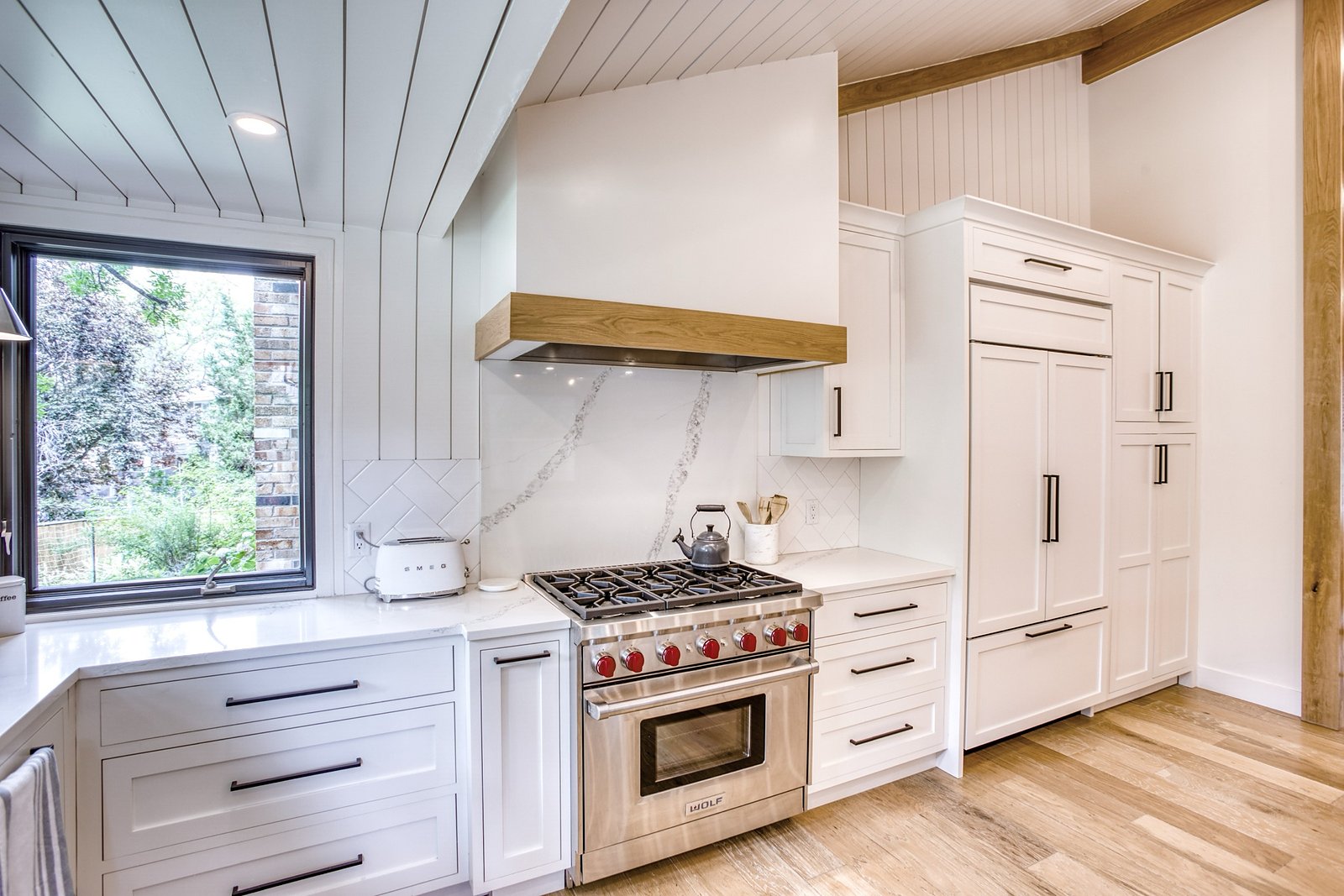 Range and custom hood with warm wood trim, Fulton Street whole house renovation in Greenwood Village