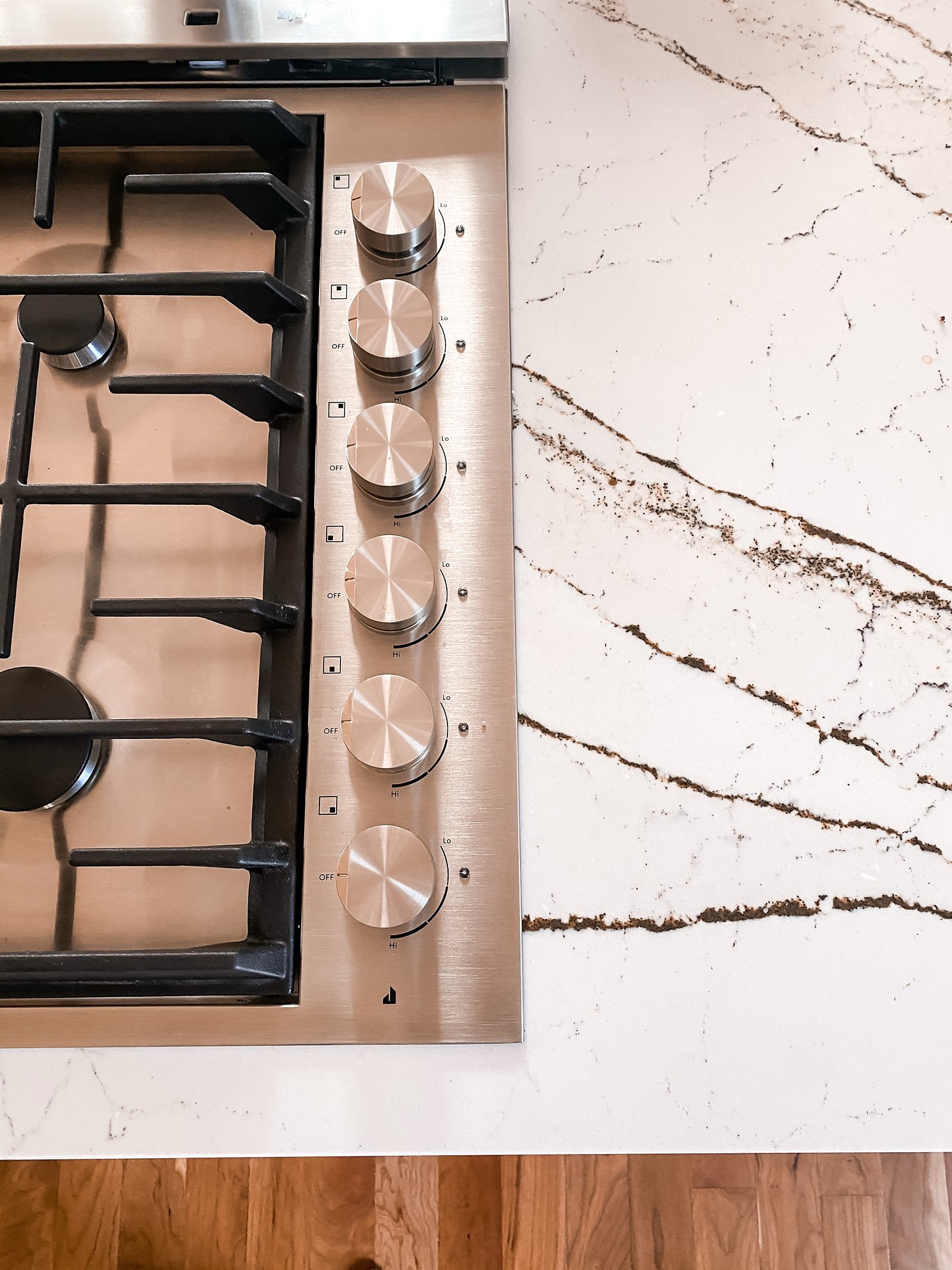 Gas cooktop set into veined quartz counters, historic Colorado Springs kitchen remodel