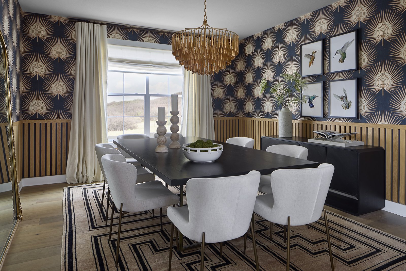 Entry with teal paneled wall, round mirror, and rust velvet stools in The Canyons at Castle Pines