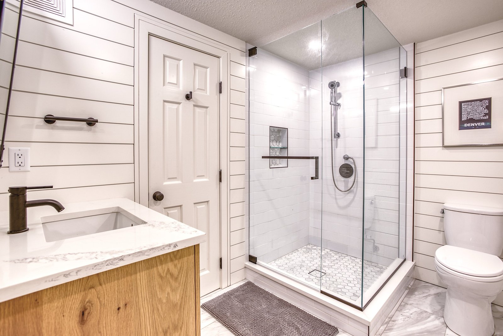 Shower with grab-safe styling and frameless glass, Fulton Street whole house renovation in Greenwood Village