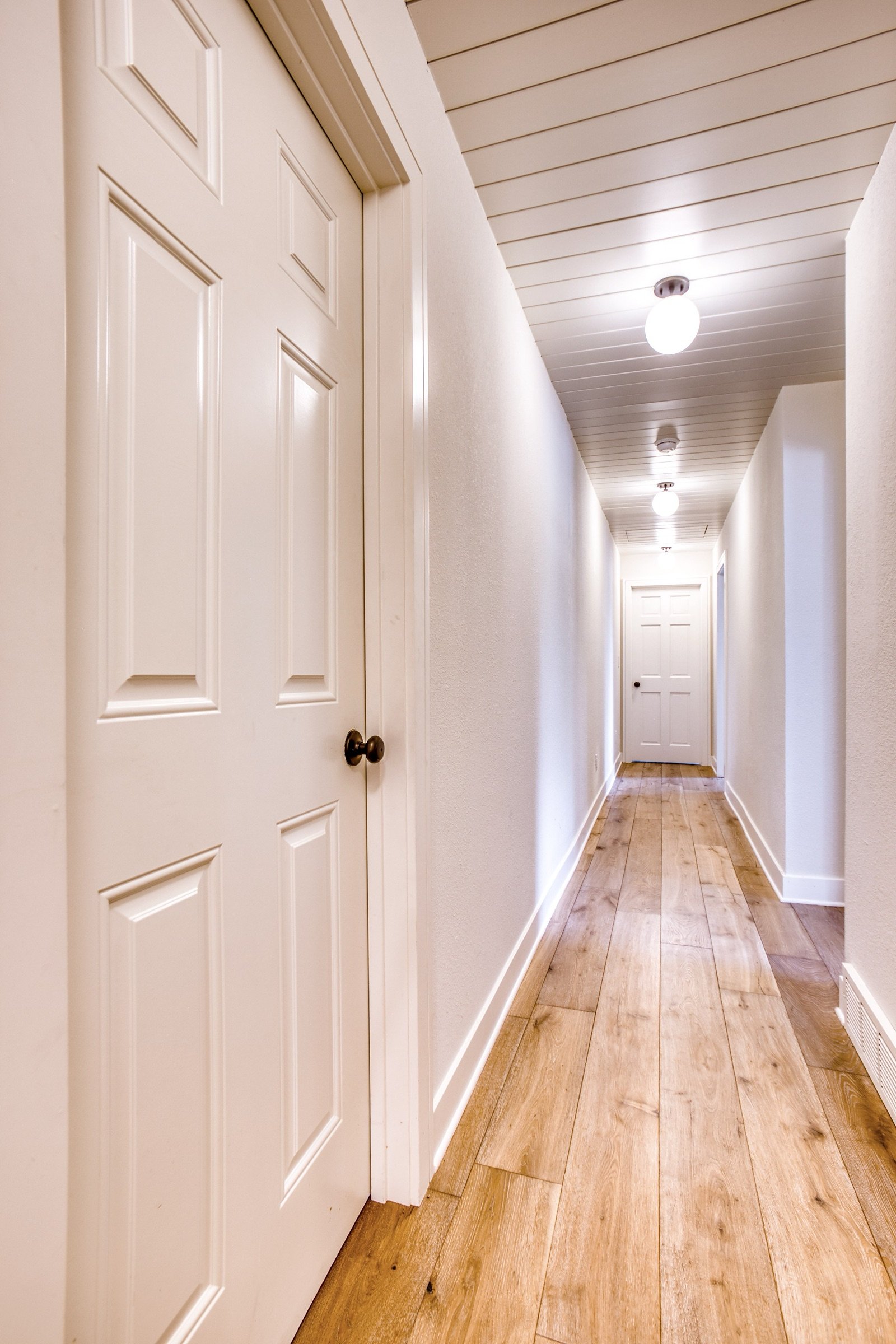 Landing with bent-wood accent chair, Fulton Street whole house renovation in Greenwood Village