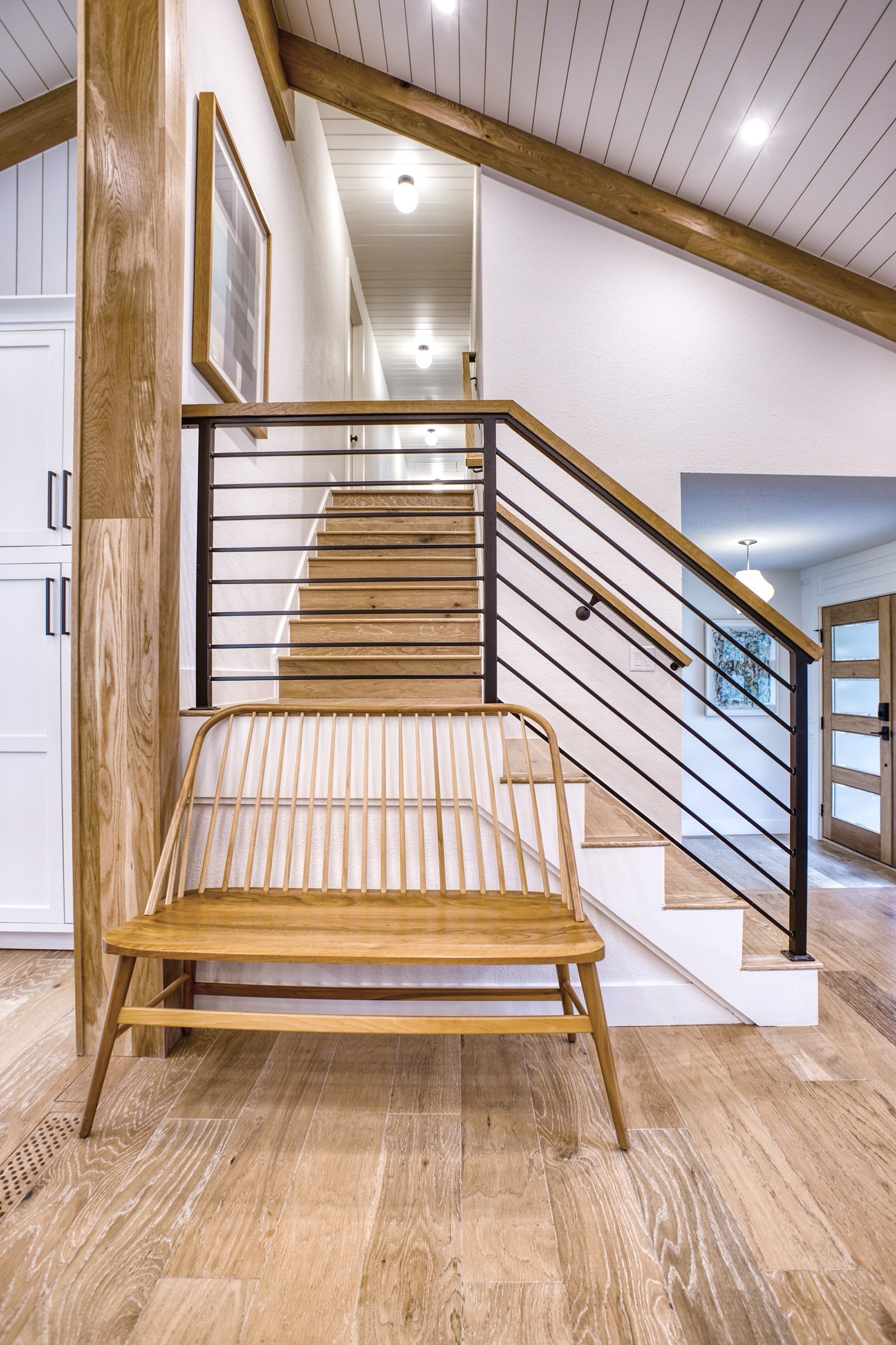Sunken lounge with glass rail and white oak stairs, Fulton Street whole house renovation in Greenwood Village