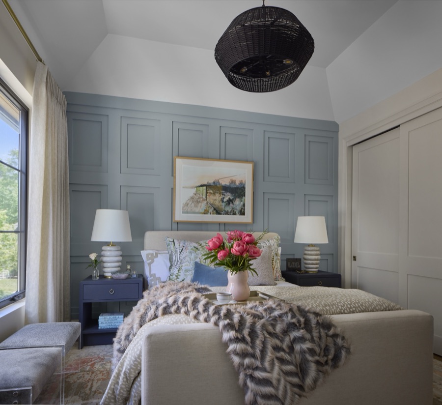 Layered sitting room with soft blue paneling, curated art, and collected furnishings styled by E+E Design Consulting