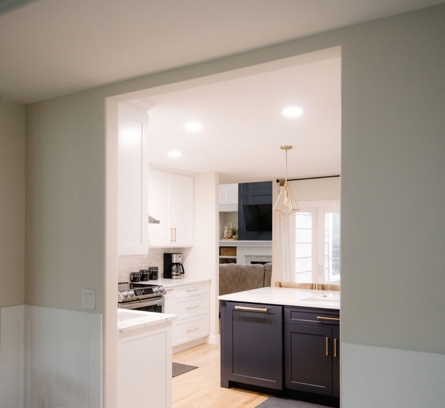 Butler's pass-through with navy base cabinets and white uppers, Stonegate main floor renovation in Parker, Colorado