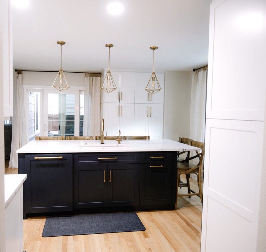 Navy island with brass pulls and white quartz waterfall edges, Stonegate main floor renovation in Parker, Colorado