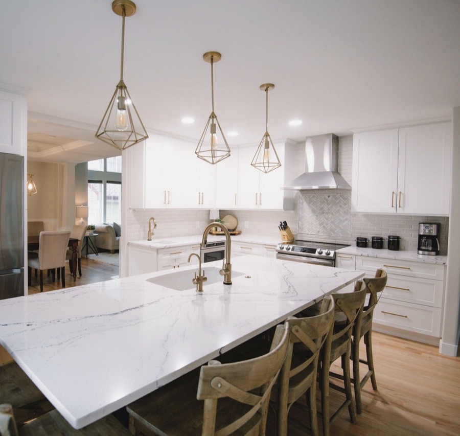 Island seating for family gatherings with wood cross-back stools, Stonegate main floor renovation in Parker, Colorado