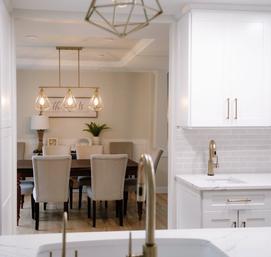 Dining room with upholstered chairs and view into the renovated kitchen, Stonegate main floor renovation in Parker, Colorado