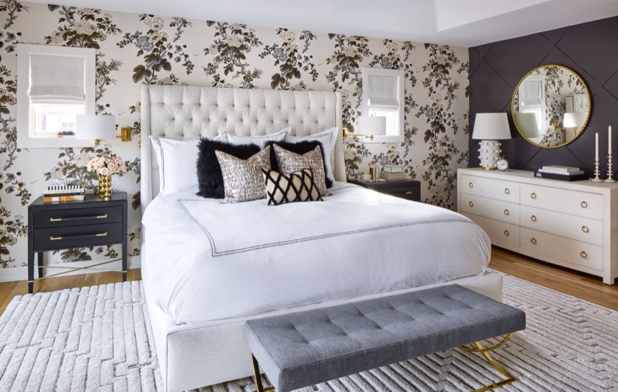 Primary bedroom with white tufted bed, dark floral wallpaper, and black X-paneled accent wall from E+E's Bonnie Brae whole home renovation